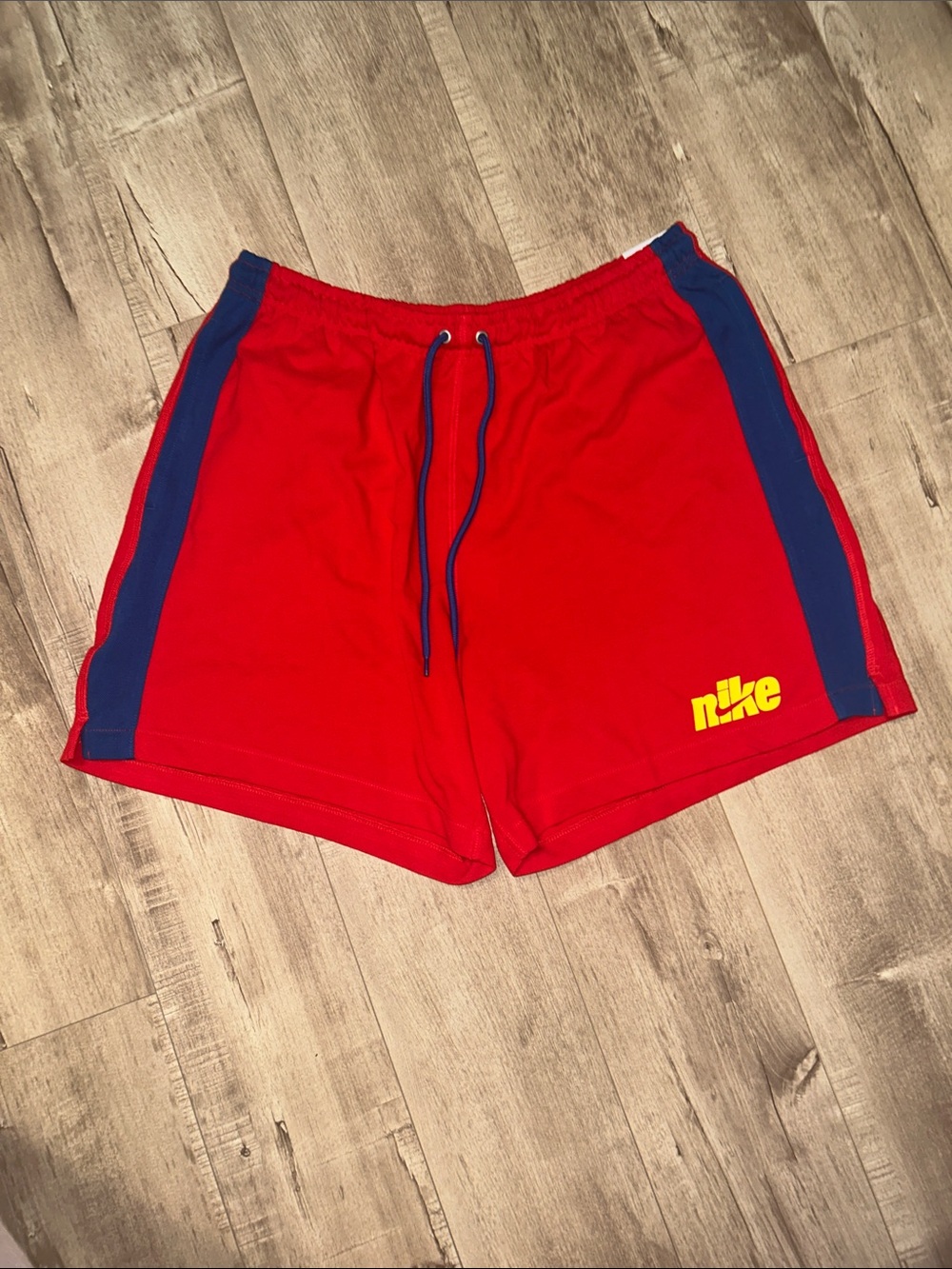 Nike Red Athletic Shorts with Blue Side Panels and Yellow Logo